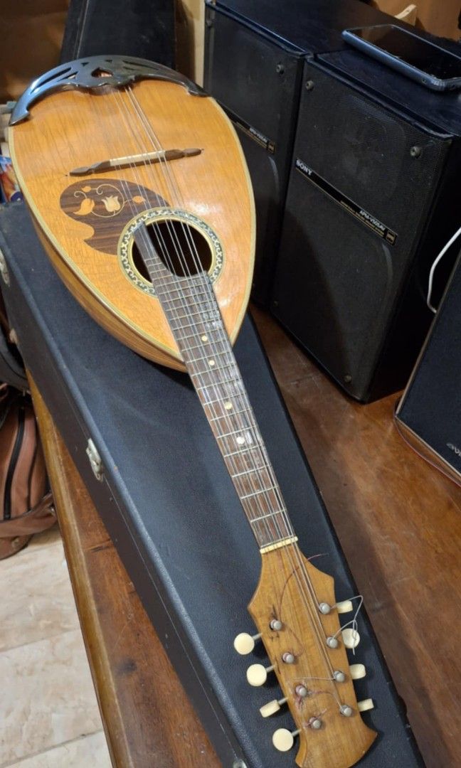 Suzuki Mandolin No. 203 (Category: Musical Instruments) located in Quezon City. Submitted by mg.q.m (Listing ID 1407318686, Image 1). Description: - Suzuki Mandolin, Model 203 - Made in Japan by Suzuki Violin Co., Ltd. - Wooden body well kept, preserved condition - Decorative border around the soundhole - Strings visible.
