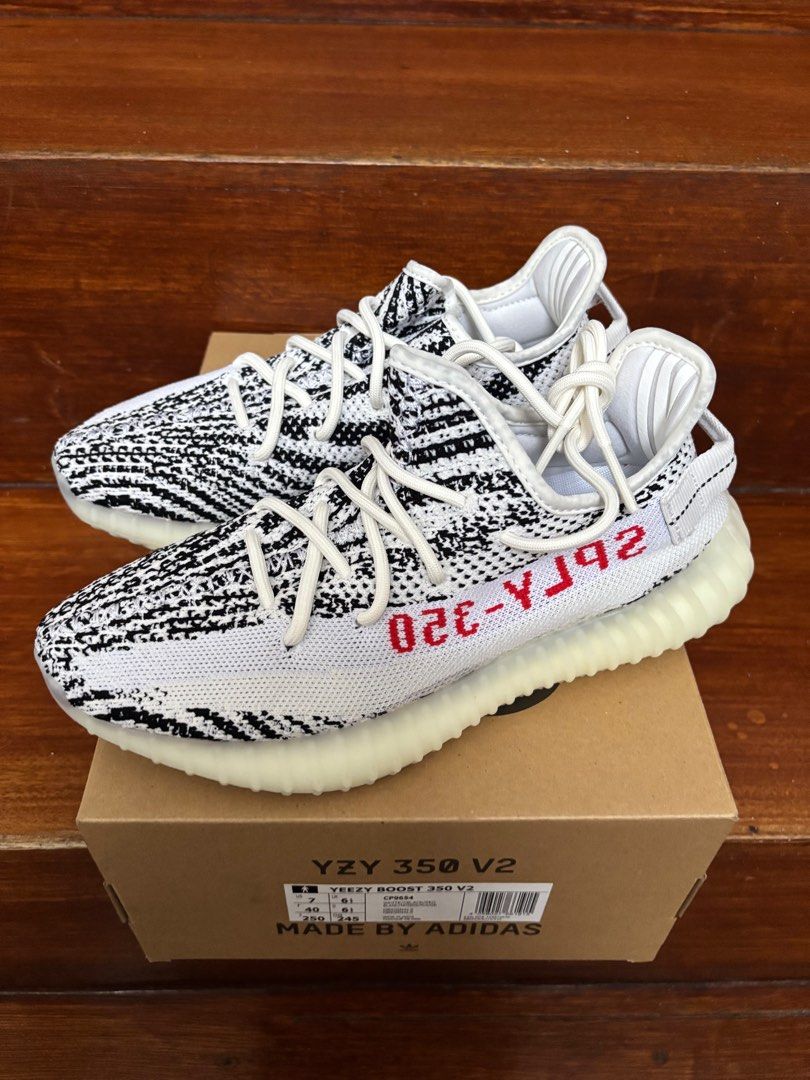 Adidas Yeezy Boost 350 V2 Zebra (Category: Sneakers) located in Caloocan City. Submitted by kangulo (Listing ID 1408949716, Image 3). Description: Adidas Yeezy Boost 350 V2 Zebra sneakers. Features a white and black striped Primeknit upper with a white midsole. The iconic "SPLY-350" text is visible on the side. Comes with the original box. Size US 7..