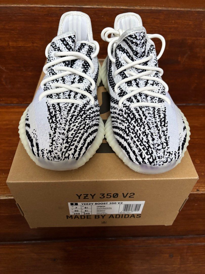 Adidas Yeezy Boost 350 V2 Zebra (Category: Sneakers) located in Caloocan City. Submitted by kangulo (Listing ID 1408949716, Image 1). Description: Adidas Yeezy Boost 350 V2 Zebra sneakers. Features a white and black striped Primeknit upper with a white midsole. The iconic "SPLY-350" text is visible on the side. Comes with the original box. Size US 7..