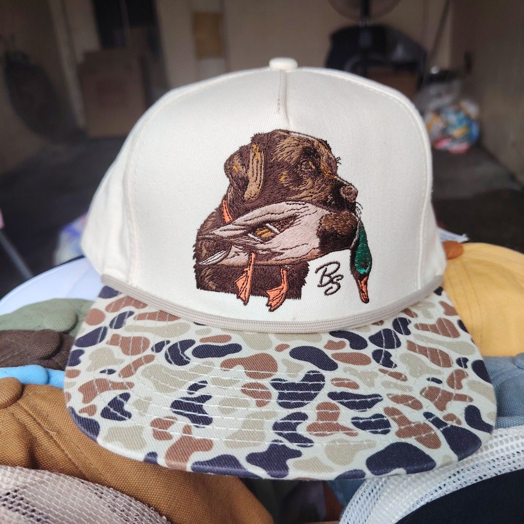 Barnes Store Hat Co. Cap (Category: Caps & Hats) located in Quezon City. Submitted by rvco_stuff (Listing ID 1408923612, Image 1). Description: - Unique cap design: Dog holding a duck on the front - Camouflage pattern on the brim - Cream-colored crown - Made of 100% cotton - Brand: Barnes Store Hat Co. - Adjustable strap for a comfortable fit.