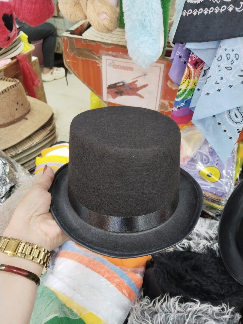 Black Top Hats (Category: Shirts) located in Manila. Submitted by neojamesca55018 (Listing ID 1408911794, Image 3). Description: - Classic black top hat - Ideal for costumes, parties, and performances - Features a tall crown and wide brim - Made of a felt-like material - Includes a black ribbon around the base.