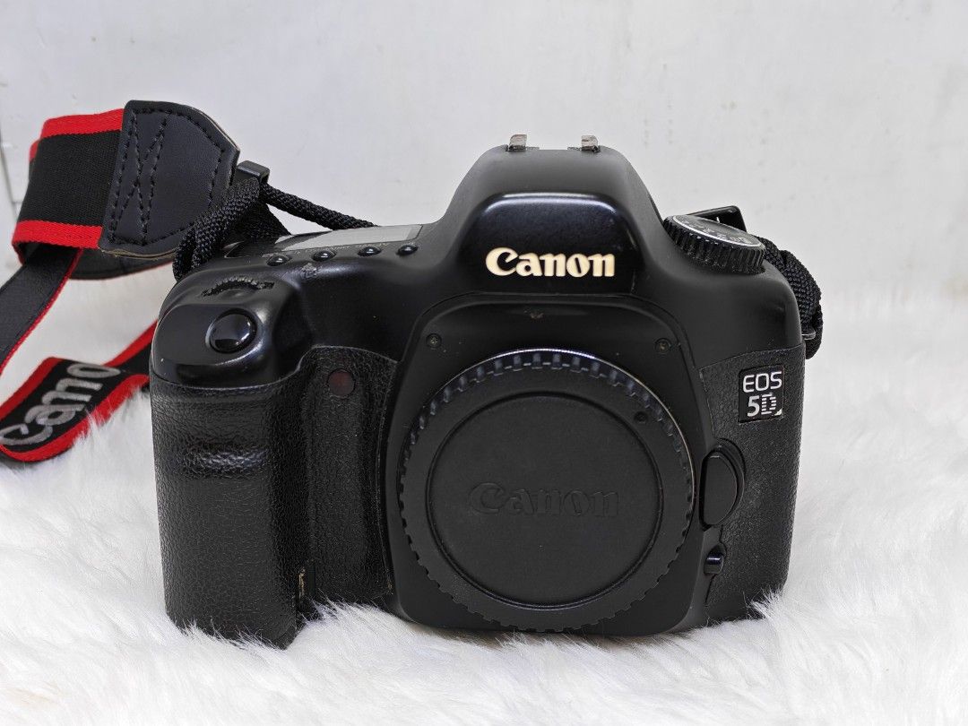 Canon EOS 5D mark 1 DSLR Camera body (Category: Cameras) located in Manila. Submitted by ultimogizmos (Listing ID 1408887405, Image 1). Description: - Canon EOS 5D DSLR camera - Includes lens cap and strap - Black body with Canon branding - Features screen, buttons, and dials - Canon logo on strap The Canon 5D Mark I (or "Classic") is a landmark 12.8MP full-frame DSLR known for making full-frame photography affordable, offering a robust build, ex