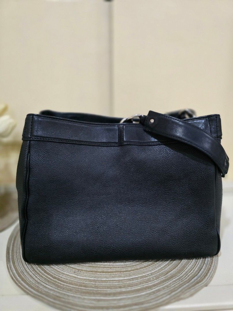 Authentic Chanel Black Leather Tote Bag (Category: Luxury Bags & Wallets) located in Davao. Submitted by bella0613 (Listing ID 1408932544, Image 3). Description: - Authentic Chanel tote bag - Black leather - Chain straps - Iconic Chanel logo embossed on front - Structured shape with flat base - Protective metal feet - Interior branded label: "CHANEL MADE IN ITALY" - Holo intact - Authenticated.