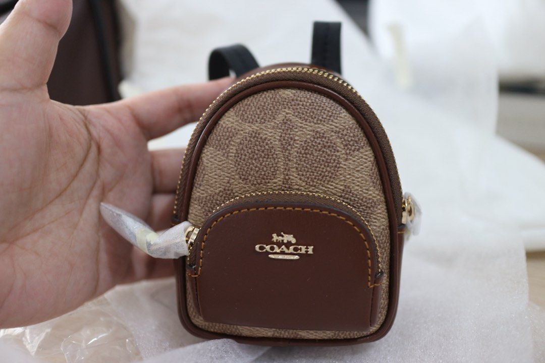 Coach Mini Court Backpack Bag Charm (Category: Luxury Bags & Wallets) located in Quezon City. Submitted by juvyjuvydoo (Listing ID 1408890886, Image 2). Description: - Authentic Coach bag charm - Miniature backpack design - Features the classic Coach monogram pattern - Brown leather pocket - Zipper closure - Small black straps - Coach logo visible - Bought from the US, no paperbag.