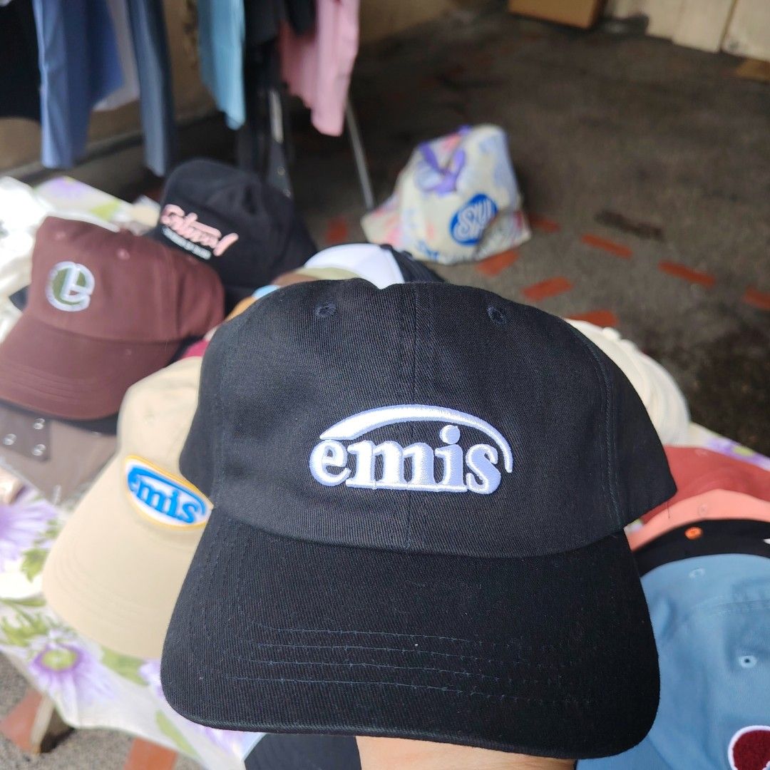 Emis Black Cap (Category: Caps & Hats) located in Quezon City. Submitted by rvco_stuff (Listing ID 1408923138, Image 1). Description: Emis black cap. Features the brand's logo embroidered on the front. The cap is made of 100% cotton and is made in Korea. The back of the cap has the text "E17-21"..