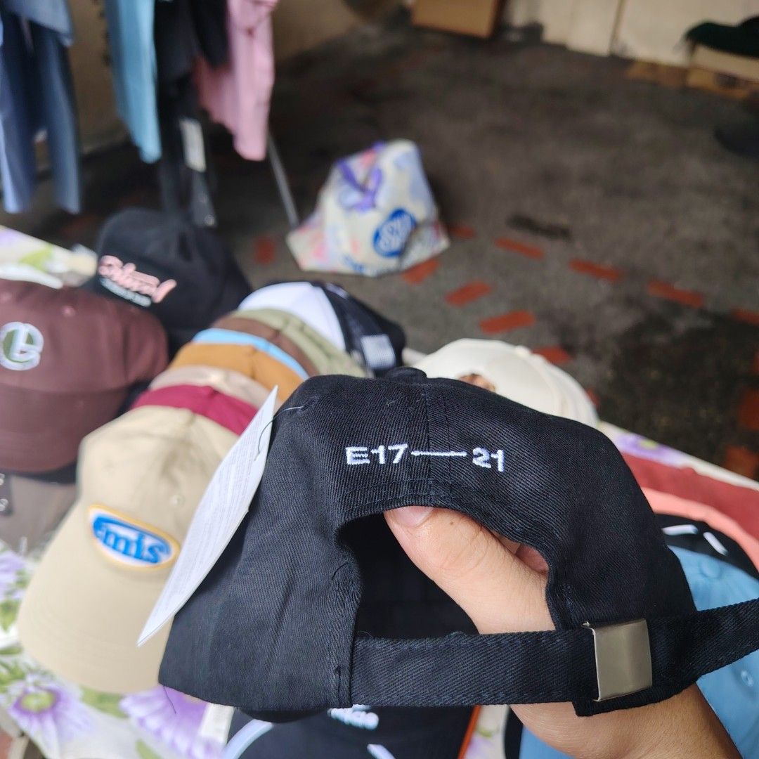 Emis Black Cap (Category: Caps & Hats) located in Quezon City. Submitted by rvco_stuff (Listing ID 1408923138, Image 2). Description: Emis black cap. Features the brand's logo embroidered on the front. The cap is made of 100% cotton and is made in Korea. The back of the cap has the text "E17-21"..