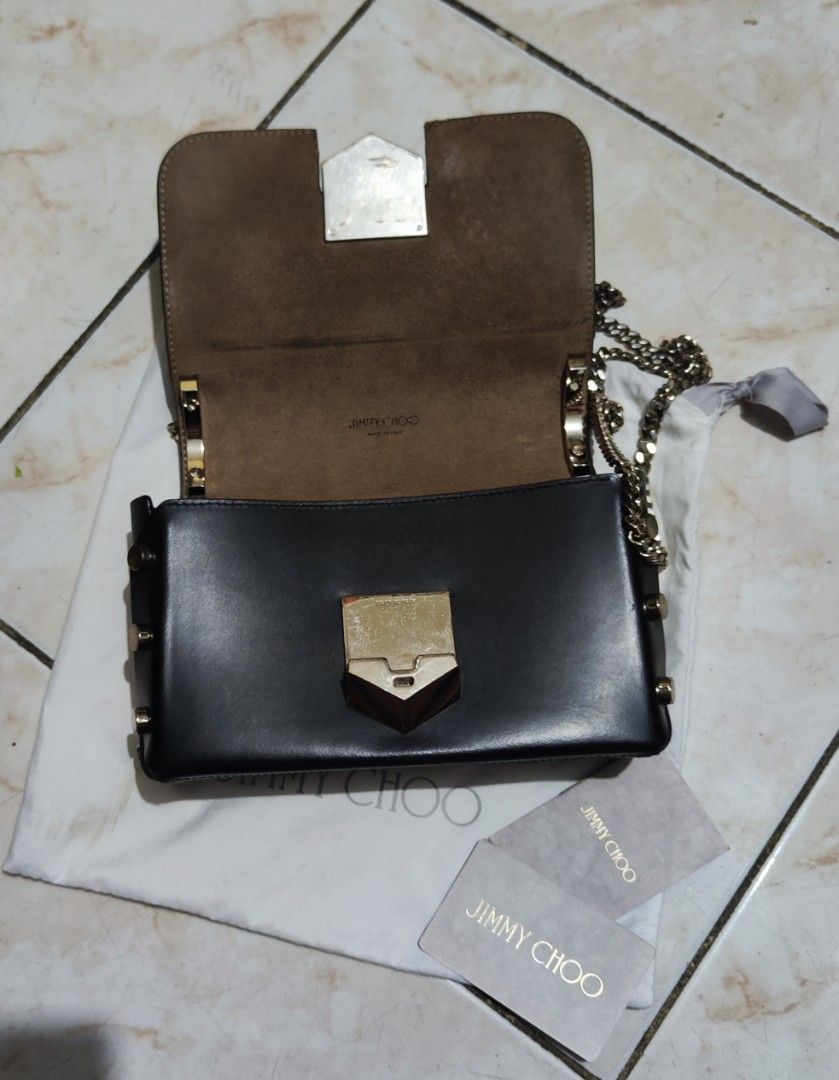 Jimmy Choo Black Shoulder Bag (Category: Luxury Bags & Wallets) located in Quezon City. Submitted by phoejay (Listing ID 1409014480, Image 2). Description: - Authentic Jimmy Choo shoulder bag - Classic black color - Elegant silver -tone clasp and chain strap - Includes original dust bag and cards - Rectangular shape with studded side details - Interior lined with a lighter-colored material.