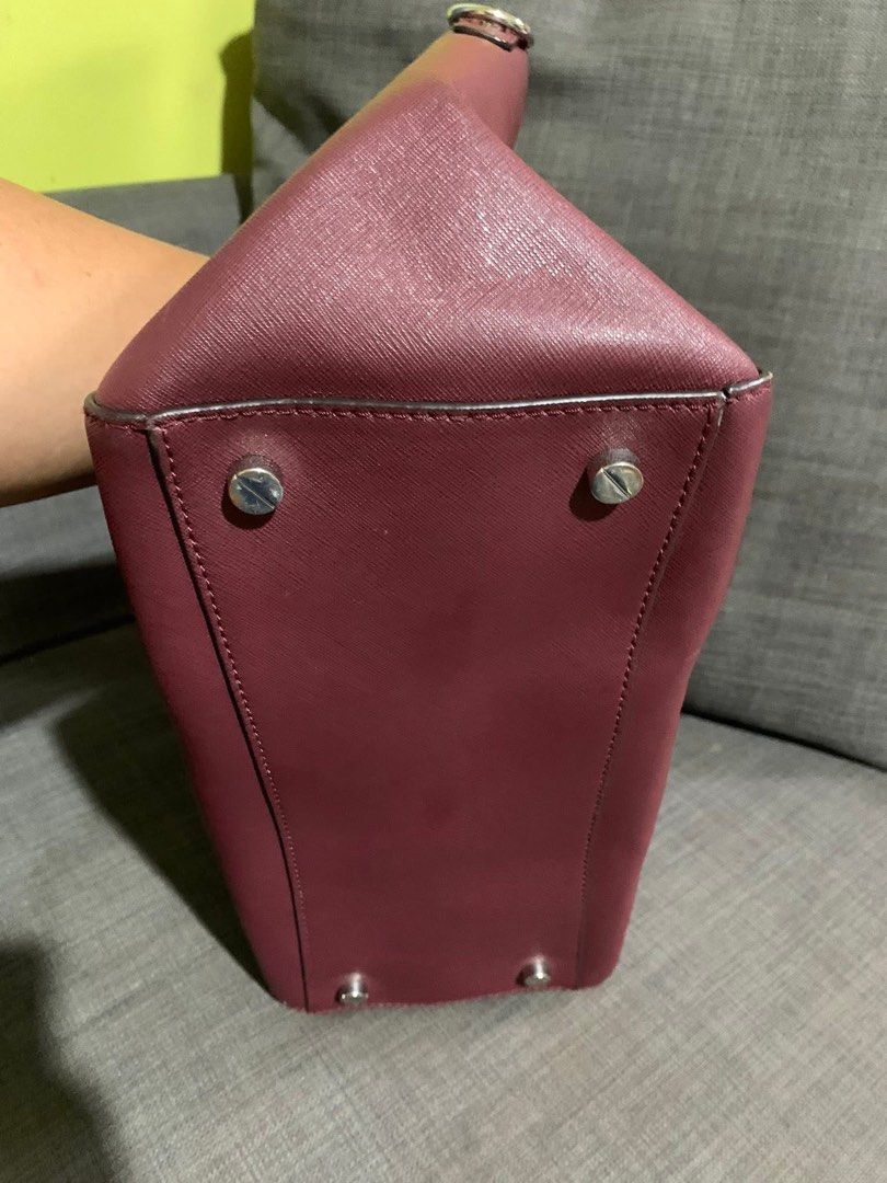 Michael Kors Satchel Handbag (Category: Luxury Bags & Wallets) located in Liloan. Submitted by jinalyns (Listing ID 1409018604, Image 3). Description: - Burgundy Michael Kors satchel handbag - Dual top handles - Silver-tone hardware - Zip closure - Interior pockets and branded lining - Structured shape - Protective metal feet - Small metal logo.