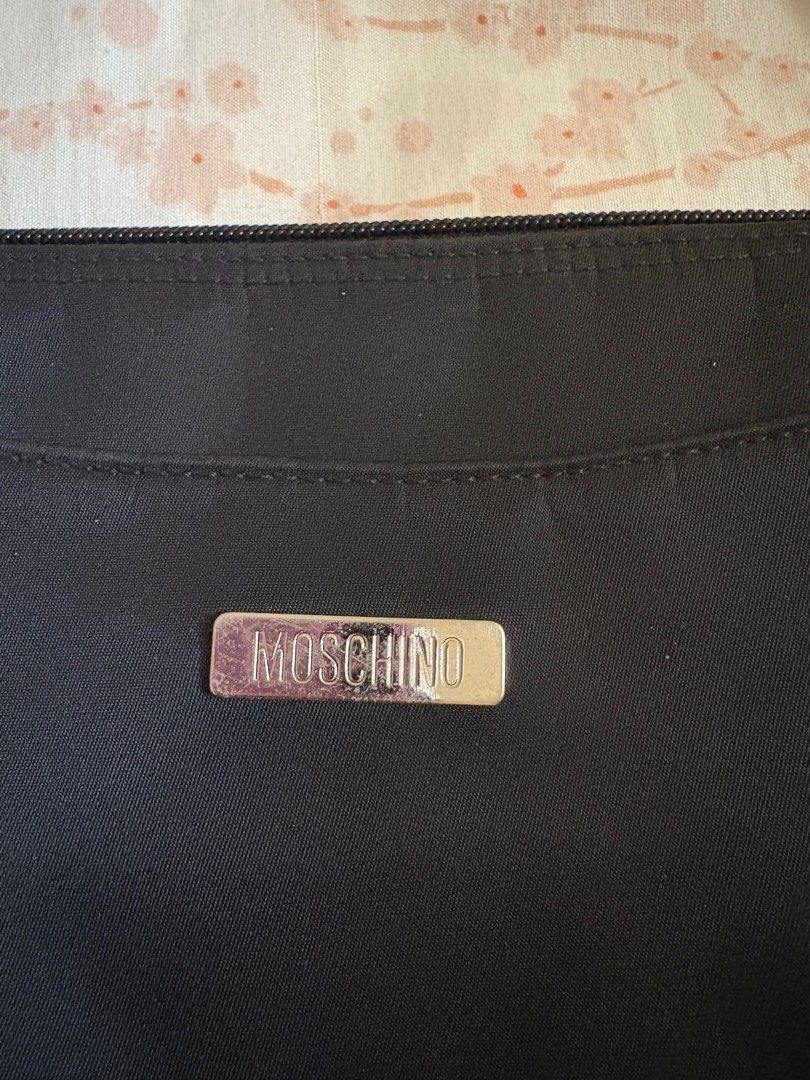 Moschino Black Handbag (Category: Luxury Bags & Wallets) located in Cavite. Submitted by yoongiiiahh (Listing ID 1406266982, Image 3). Description: - Moschino black handbag - Top handle design - Rectangular shape - Small metal logo detail - Made of a nylon-like material - Zipper closure.