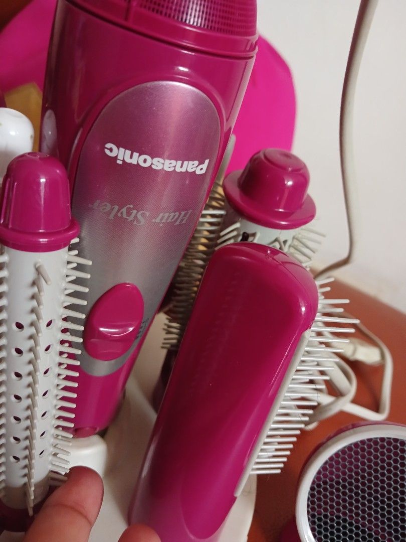 Panasonic Hair Styler EH7920 (Category: Hair) located in Marikina City. Submitted by laila15 (Listing ID 1408903757, Image 2). Description: - Panasonic EH7920 hair styler - Includes various brush heads and a diffuser - Stylish pink and white design - Comes with a power cord - Not used got stock only - Good working condition.