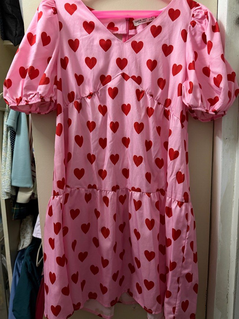 Pink Heart Print Dress (Category: Dresses) located in Cavite. Submitted by fashyph (Listing ID 1408894233, Image 1). Description: - Pink mini dress with red heart print - V-neckline - Short puff sleeves - Tiered skirt - Zipper closure at the back - Made of lightweight material - Ideal for casual wear 12t on tag but runs big fits xs-s Like new no flaw.