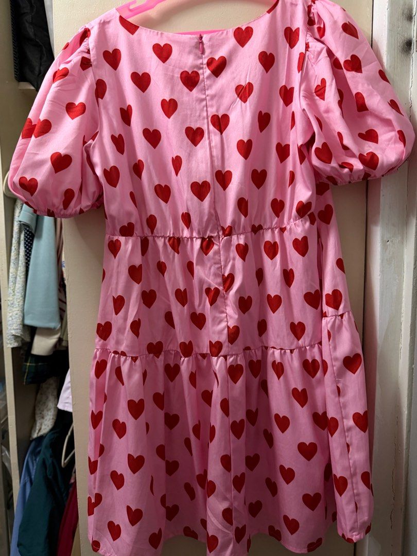 Pink Heart Print Dress (Category: Dresses) located in Cavite. Submitted by fashyph (Listing ID 1408894233, Image 2). Description: - Pink mini dress with red heart print - V-neckline - Short puff sleeves - Tiered skirt - Zipper closure at the back - Made of lightweight material - Ideal for casual wear 12t on tag but runs big fits xs-s Like new no flaw.