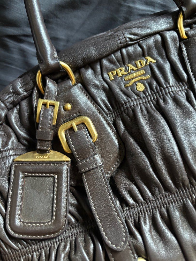 Prada Nappa Gaufre (Category: Luxury Bags & Wallets) located in Los Banos. Submitted by declutterlistt (Listing ID 1408898926, Image 3). Description: Selling my mom’s old bag. - Authentic - Brown leather - Ruched design - Gold-tone hardware - Top handle - Detachable shoulder strap - Includes dust bag and authenticity card - Prada logo lining and zippered pocket inside Seller is based in Laguna and meetups will be on January 2 to January 3 in MOA.