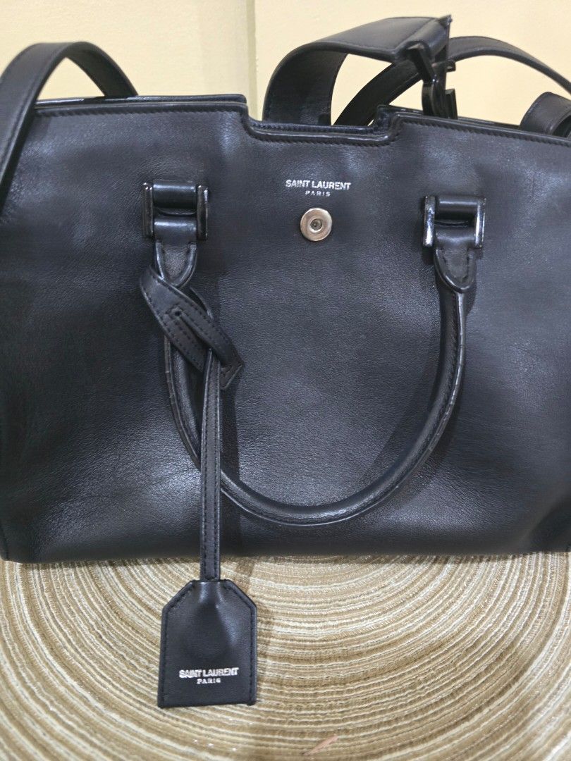 YSL Sac De Jour Handbag (Category: Luxury Bags & Wallets) located in Davao. Submitted by bella0613 (Listing ID 1408978448, Image 3). Description: - Authentic Saint Laurent Sac De Jour handbag in black. - Features a classic top handle design. - Includes a detachable shoulder strap for versatile carrying options. - Secure zipper closure. - Iconic Saint Laurent logo on the front. - Interior includes a serial number and "Made in Italy" stamp. - Comes