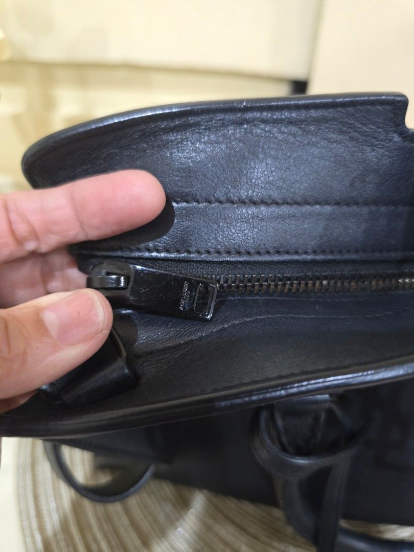 YSL Sac De Jour Handbag (Category: Luxury Bags & Wallets) located in Davao. Submitted by bella0613 (Listing ID 1408978448, Image 2). Description: - Authentic Saint Laurent Sac De Jour handbag in black. - Features a classic top handle design. - Includes a detachable shoulder strap for versatile carrying options. - Secure zipper closure. - Iconic Saint Laurent logo on the front. - Interior includes a serial number and "Made in Italy" stamp. - Comes