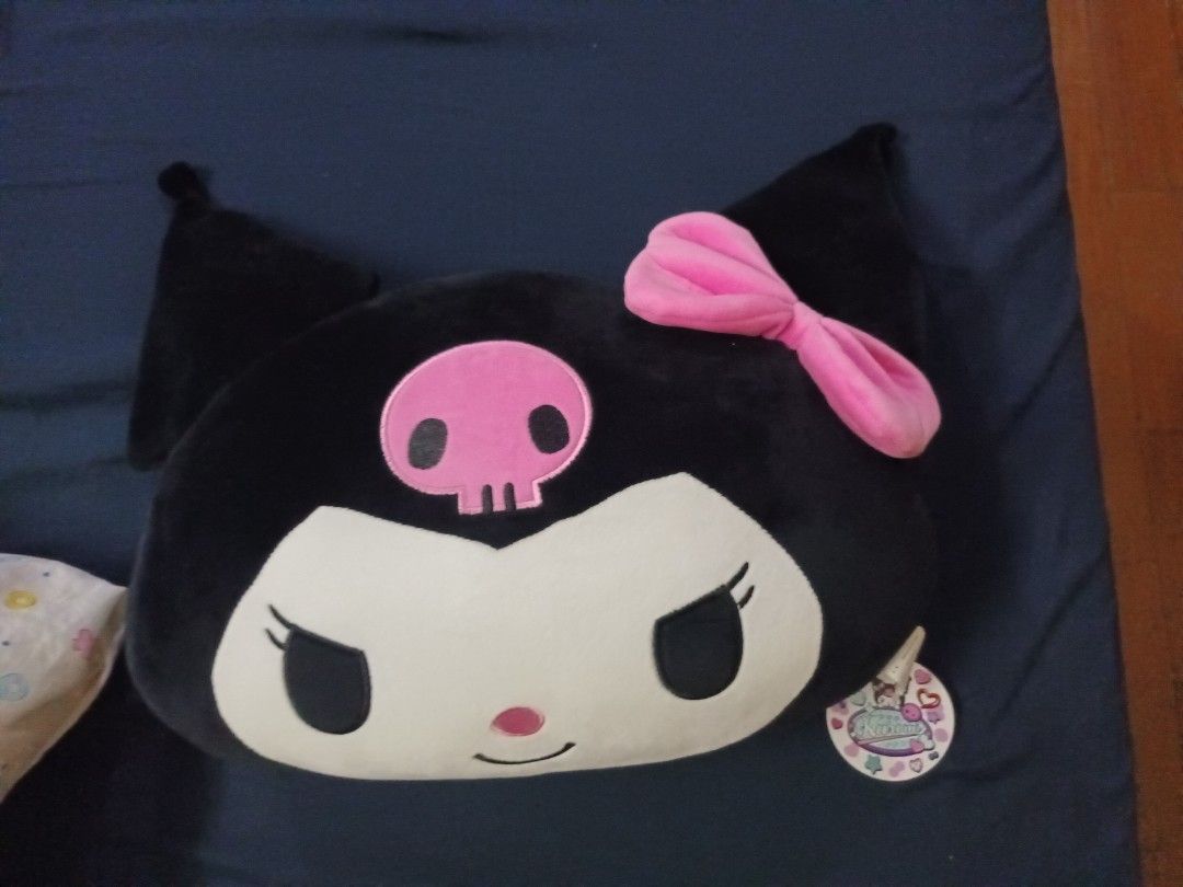 Sanrio Kuromi Head Pillow (Category: Plushies & Soft Toys) located in Quezon City. Submitted by limsys08 (Listing ID 1409032458, Image 2). Description: Hey there, Kuromi fans! Check out this super cute Sanrio Kuromi Head Pillow! Look at that adorable Kuromi face, complete with her signature skull and pink bow. Perfect for your bed, sofa, or anywhere you need a touch of Sanrio magic. It's soft, huggable, and guaranteed to bring a smile to your fac