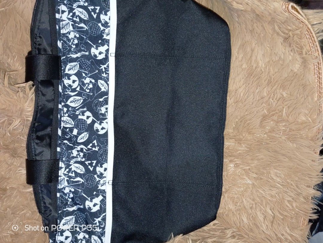 Adidas Golf Bag (Category: Golf) located in Bulacan. Submitted by anzhee (Listing ID 1409102024, Image 2). Description: - Adidas golf bag - Black and white design - Adidas Golf logo on front - Top handle for easy carrying - Secure zipper closure - Interior with a separate compartment - Patterned top section.