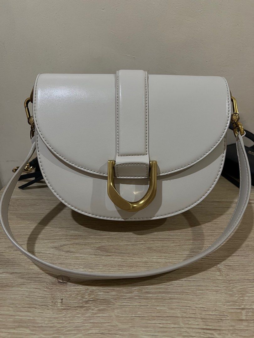 Charles & Keith Saddle Bag (Category: Luxury Bags & Wallets) located in Rizal. Submitted by thedailypouch (Listing ID 1409172923, Image 1). Description: Rfs: decluttering - Charles & Keith saddle bag -original 💯 - Color: Crown - Stylish curved design - Gold-tone buckle - Detachable shoulder strap - Style number: CK2-80781610-1 - Interior: Zippered pocket - Branded with Charles & Keith logo.