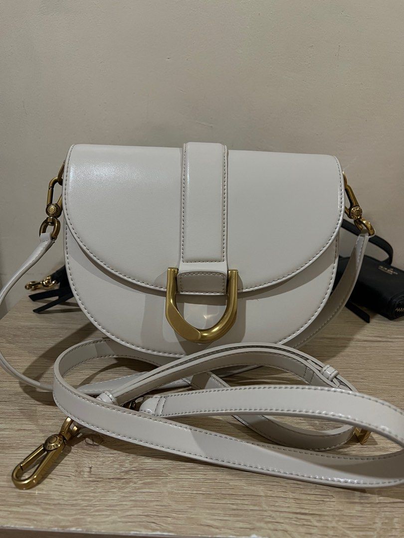 Charles & Keith Saddle Bag (Category: Luxury Bags & Wallets) located in Rizal. Submitted by thedailypouch (Listing ID 1409172923, Image 3). Description: Rfs: decluttering - Charles & Keith saddle bag -original 💯 - Color: Crown - Stylish curved design - Gold-tone buckle - Detachable shoulder strap - Style number: CK2-80781610-1 - Interior: Zippered pocket - Branded with Charles & Keith logo.