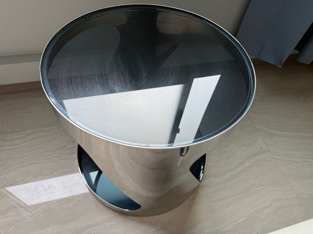 Coffee table (small) (Category: Tables & Sets) located in Singapore. Submitted by ycachong (Listing ID 1409190893, Image 3). Description: Coffee table (round) with steel chrome frame and grey tinted tempered glass top and bottom (48cm x 47cm), RRP S$399.