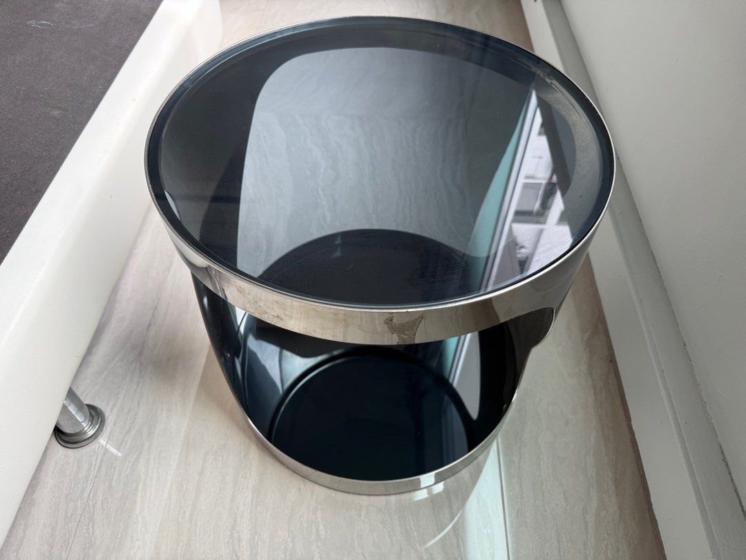 Coffee table (small) (Category: Tables & Sets) located in Singapore. Submitted by ycachong (Listing ID 1409190893, Image 2). Description: Coffee table (round) with steel chrome frame and grey tinted tempered glass top and bottom (48cm x 47cm), RRP S$399.