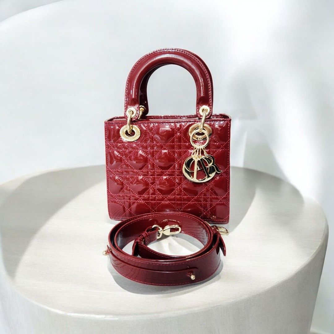 Dior Lady Dior Mini Bag (Category: Luxury Bags & Wallets) located in Mabini. Submitted by wearandcarry (Listing ID 1409213891, Image 1). Description: - small Lady Dior bag - Burgundy patent calfskin - Iconic Cannage stitching - Top handle - Detachable shoulder strap - Gold-tone hardware - Signature Dior charms - Stylish and compact.