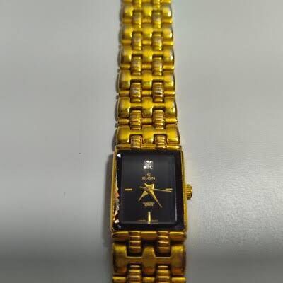 Elgin Diamond Quartz Watch (Category: Women's Watches) located in Quezon City. Submitted by ysabellashoppe (Listing ID 1409086977, Image 2). Description: - Elgin watch - Rectangular black dial - Gold-toned bracelet and case - Diamond accent - Date display - Quartz movement.