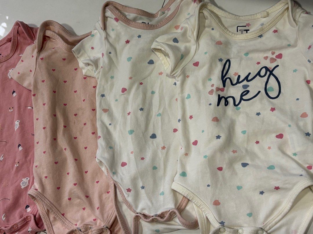 FT Baby Bodysuits - Set of 4 (Category: Babies & Kids Fashion) located in Quezon City. Submitted by things.matter (Listing ID 1409142490, Image 1). Description: - Set of four baby bodysuits - Designs: - Pink with bird and leaf pattern - Pink with heart patterns - White with star and heart patterns - White with "hug me" text - Features: - Short sleeves - Snap closures at the bottom -super soft quality yung cotton niya .