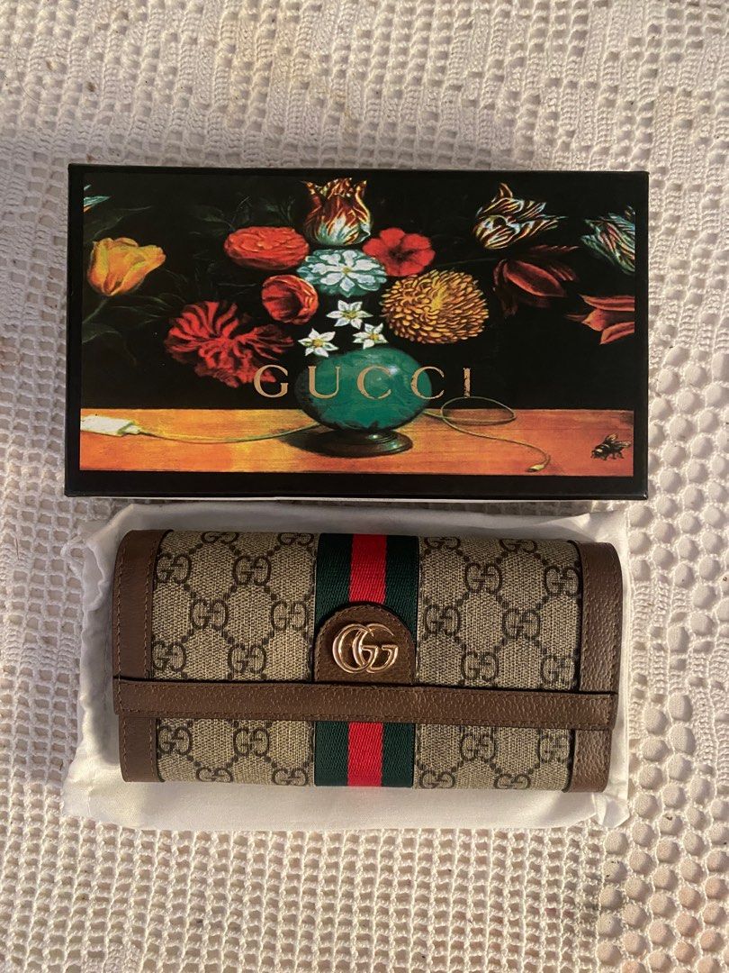Gucci GG Supreme Wallet (Category: Luxury Bags & Wallets) located in Tanza. Submitted by gwen1905 (Listing ID 1409127430, Image 1). Description: - Gucci wallet - Iconic GG Supreme canvas with green and red stripe - Multiple card slots and compartments - Includes original box - Includes dust bag - Includes authenticity cards - Dent in box.