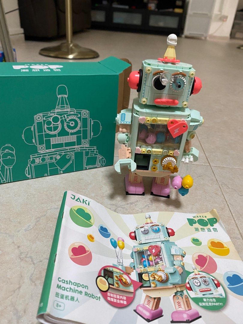 JAKI Maker Pop Gashapon Machine Robot Building Block Set (Category: Lego & Building Sets) located in Singapore. Submitted by littlegoesalongway (Listing ID 1409079019, Image 3). Description: Adorable JAKI Maker Pop Gashapon Machine Robot building block set is almost new and assembled! It features a unique design with a gashapon machine theme. Includes the instructions. Perfect for collectors or anyone who loves building blocks! We can dissemble f