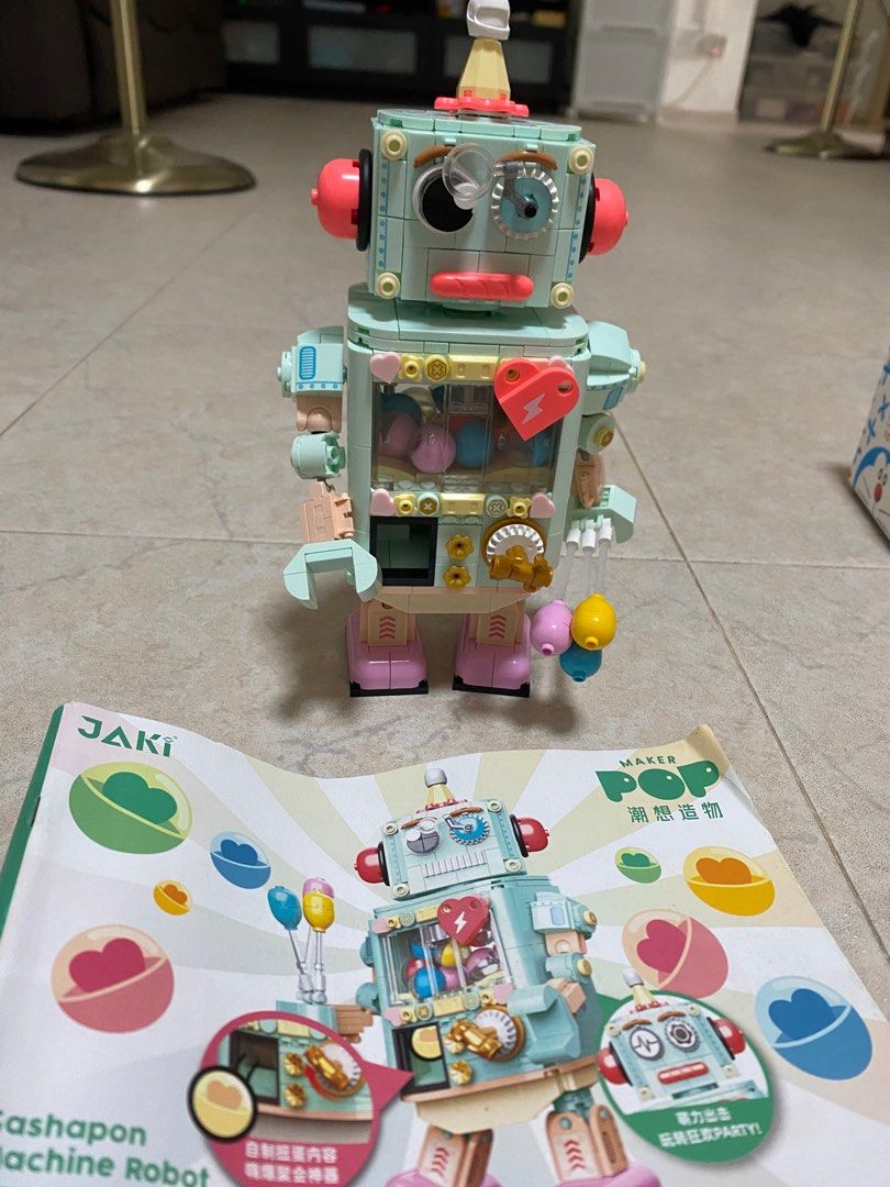 JAKI Maker Pop Gashapon Machine Robot Building Block Set (Category: Lego & Building Sets) located in Singapore. Submitted by littlegoesalongway (Listing ID 1409079019, Image 1). Description: Adorable JAKI Maker Pop Gashapon Machine Robot building block set is almost new and assembled! It features a unique design with a gashapon machine theme. Includes the instructions. Perfect for collectors or anyone who loves building blocks! We can dissemble f