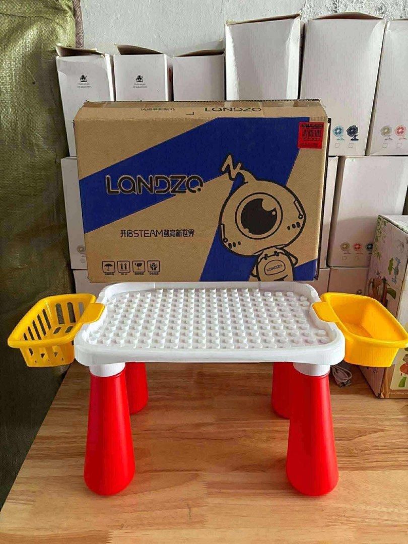 Lego Block Table (Category: Lego & Building Sets) located in Tarlac. Submitted by dgdgc (Listing ID 1409073486, Image 1). Description: - Lego Block Table - White building surface - Red legs - Includes yellow storage baskets - Perfect for kids.