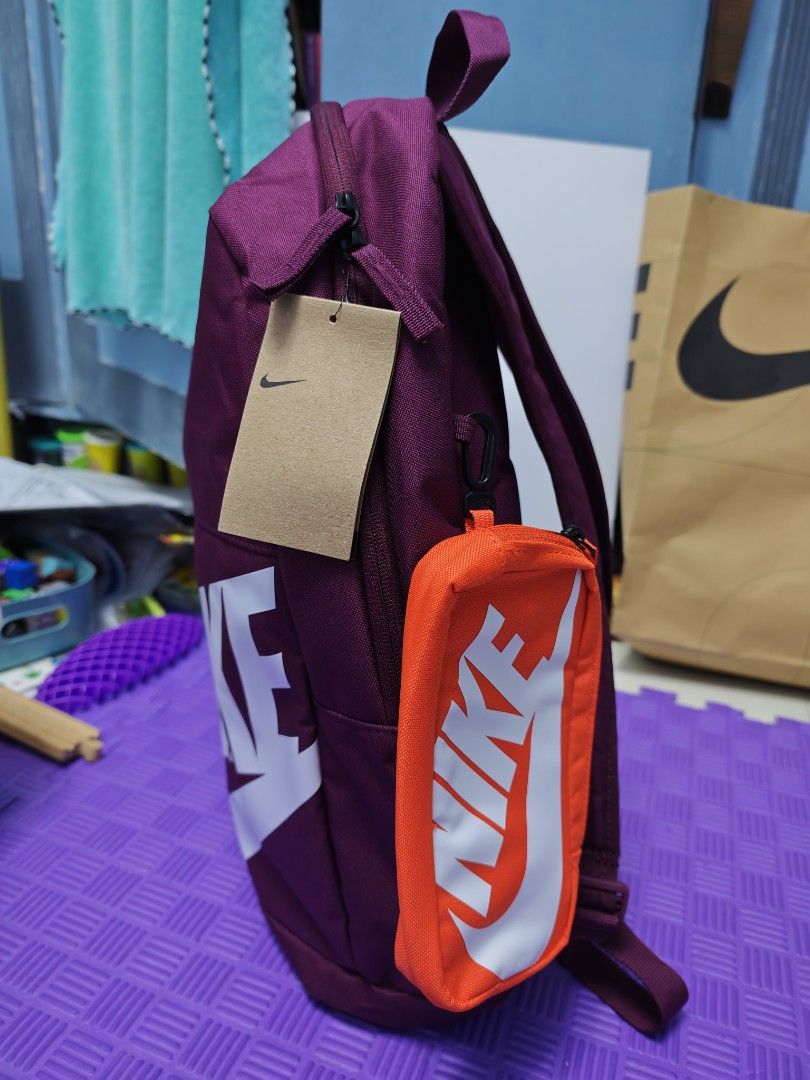 Nike Elemental Backpack with Detachable Pouch (Category: Backpacks) located in Manila. Submitted by shcfernan42981 (Listing ID 1409160511, Image 2). Description: Volume: 20L Dimensions: 18" x 12" x 5" Color: Bordeaux, Orange Regular price: 1695 - Large main compartment - Padded back and shoulder straps - 1 front zippered stash pocket - 1 external water bottle pocket - Shoebox-inspired pouch with exterior and interior attachment point.