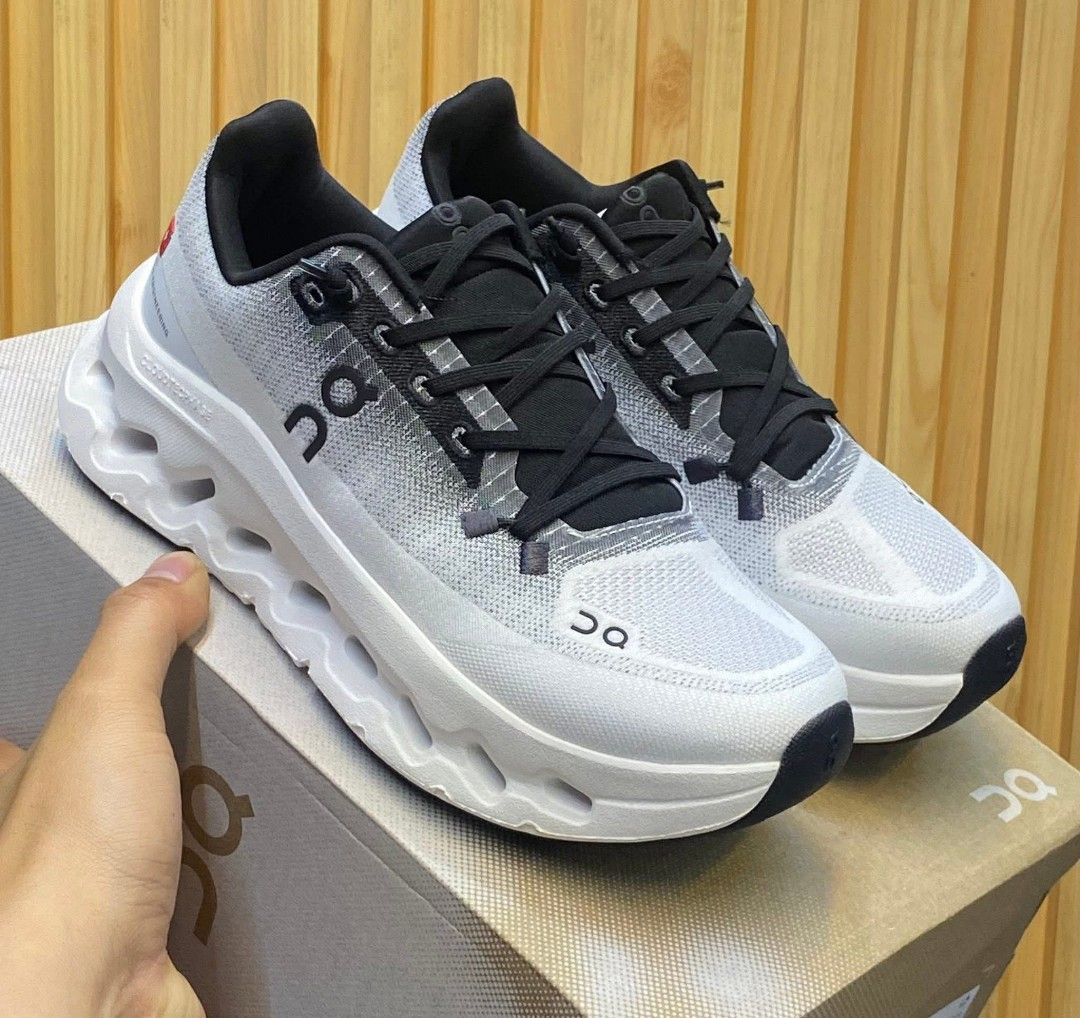 On Cloudnova & Cloud 5 Shoes (Category: Sneakers) located in Manila. Submitted by astiga (Listing ID 1409144640, Image 1). Description: - Pair 1: On Cloudnova in white and gray. Features a distinctive sole design. - Pair 2: Black On shoes with an all-black design. - Both pairs are in their original boxes. - Both pairs feature the On logo..