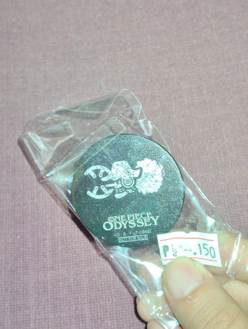 One Piece Odyssey Phone Grip popsocket (Category: Other Mobile & Gadget Accessories) located in Pasig City. Submitted by hazelscollectibles (Listing ID 1409232058, Image 1). Description: - One Piece Odyssey phone grip - Round, black design with white graphic - Brand new, in original packaging - Features a strong 3M adhesive for easy application - Price: ₱99.