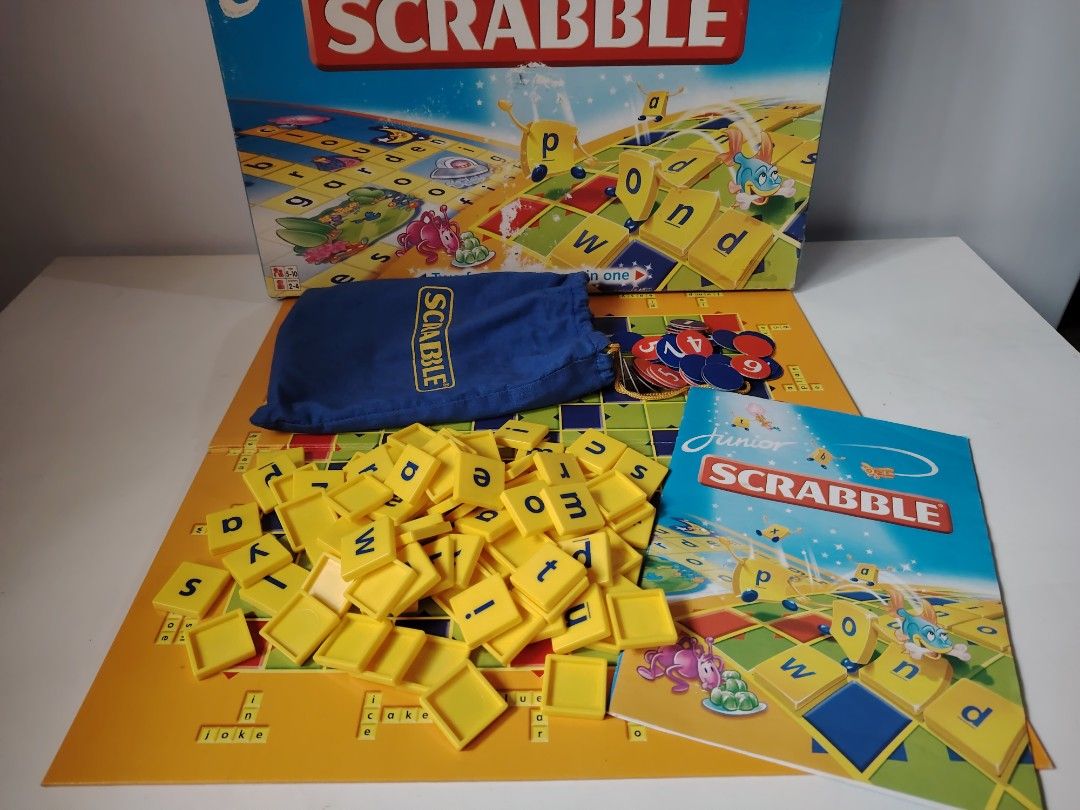 Scrabble Junior Board Game (Category: Board Games & Puzzles) located in General Trias. Submitted by Jingthings (Listing ID 1409240395, Image 1). Description: Scrabble Junior board game. Includes the game board, letter tiles, tile bag, and instructions. The box shows the Scrabble Junior logo. The game board has colorful squares and spaces for the tiles. The letter tiles are yellow. .