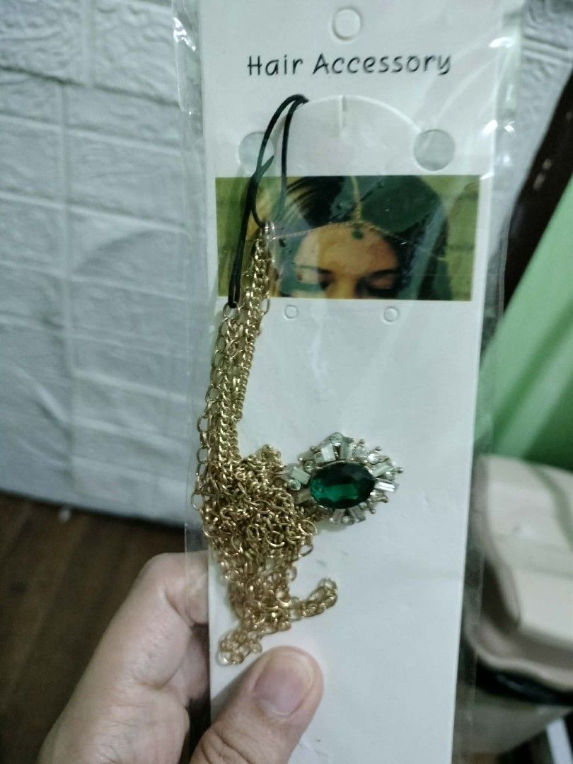 Bohemian Hair Accessory with Gemstone (Category: Hair Accessories) located in Kawit. Submitted by mariefonda (Listing ID 1409314455, Image 2). Description: - Gold-colored chain head accessory - Features a gemstone pendant - Available colors: teal and green - Brand new, still in original packaging.