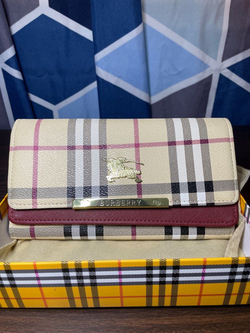 Burberry Checkered Wallet (Category: Luxury Bags & Wallets) located in Angeles City. Submitted by doooospordos (Listing ID 1409293341, Image 1). Description: - Authentic Burberry wallet - Iconic checkered pattern - Beige and burgundy color scheme - Includes matching box - Includes dust bag - Burberry logo visible.