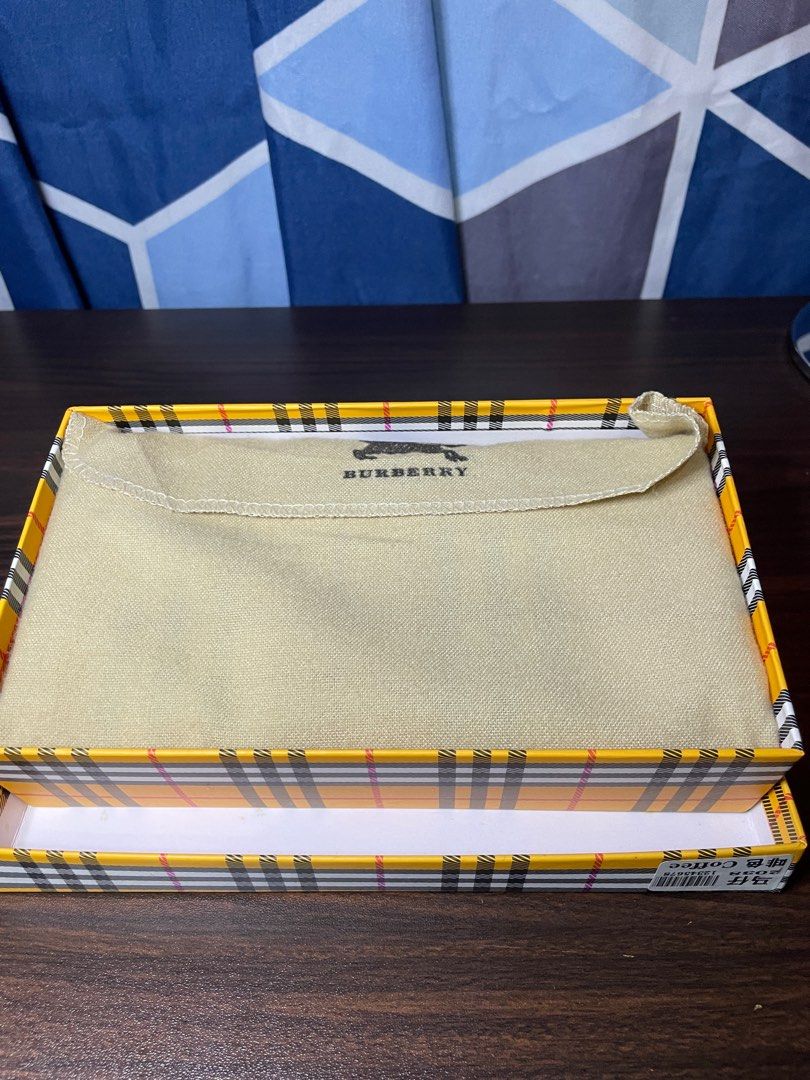 Burberry Checkered Wallet (Category: Luxury Bags & Wallets) located in Angeles City. Submitted by doooospordos (Listing ID 1409293341, Image 2). Description: - Authentic Burberry wallet - Iconic checkered pattern - Beige and burgundy color scheme - Includes matching box - Includes dust bag - Burberry logo visible.