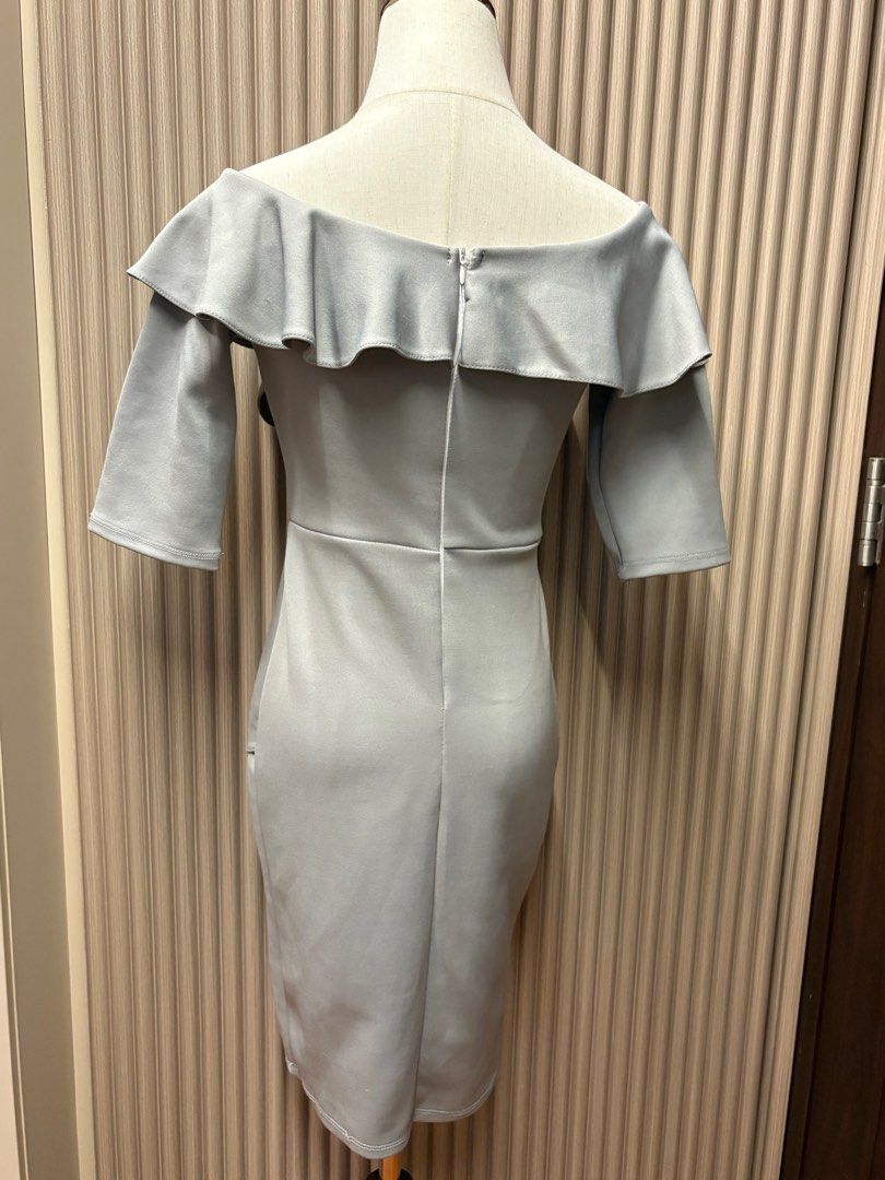 Celest Gray Off-Shoulder Dress (Category: Dresses) located in Mandaluyong City. Submitted by taraparador (Listing ID 1409374857, Image 3). Description: - Rarely used - during weddings - In good condition Elegant off-shoulder dress in a soft gray color. Features a flattering silhouette with a fitted bodice and a knee-length skirt with a side slit. The dress has short sleeves and a ruffled neckline. The back has a zipper closure..