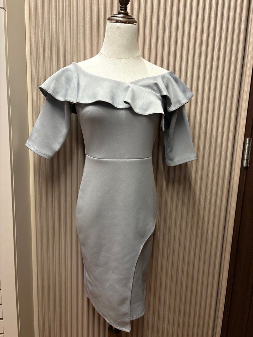 Celest Gray Off-Shoulder Dress (Category: Dresses) located in Mandaluyong City. Submitted by taraparador (Listing ID 1409374857, Image 1). Description: - Rarely used - during weddings - In good condition Elegant off-shoulder dress in a soft gray color. Features a flattering silhouette with a fitted bodice and a knee-length skirt with a side slit. The dress has short sleeves and a ruffled neckline. The back has a zipper closure..