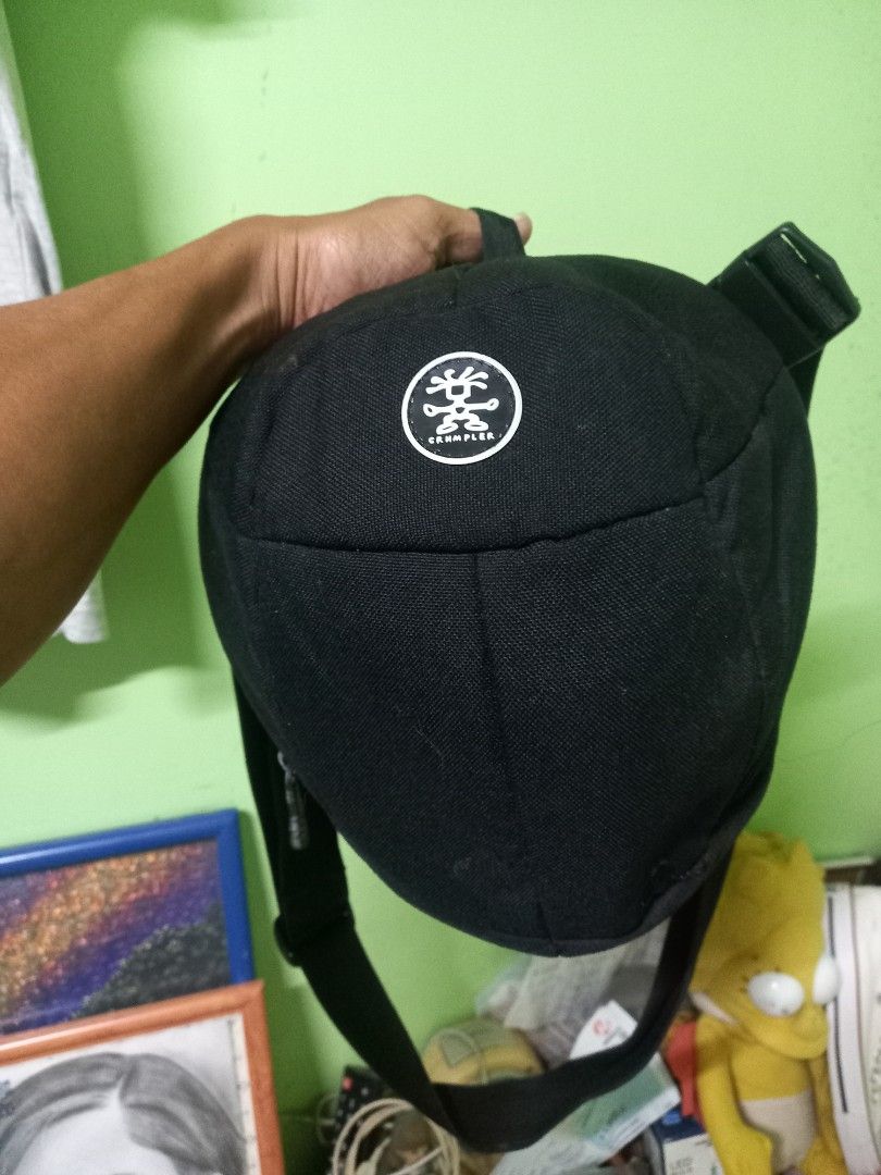 Crumpler Jimmy B 300 Sling Bag (Category: Sling Bags) located in Manila. Submitted by cristobalc40322 (Listing ID 1409284393, Image 2). Description: Black Crumpler Jimmy B 300 sling bag. Features a main compartment with a red zipper and an internal pocket. The bag has an adjustable strap and a mesh back panel for comfort. The Crumpler logo is visible on the front. EXCELLENT CONDITION NO ANYDAMAGE NO ANYSTAIN NO SCRATCHES NO FLAWS NO FLUFF LOCATIO