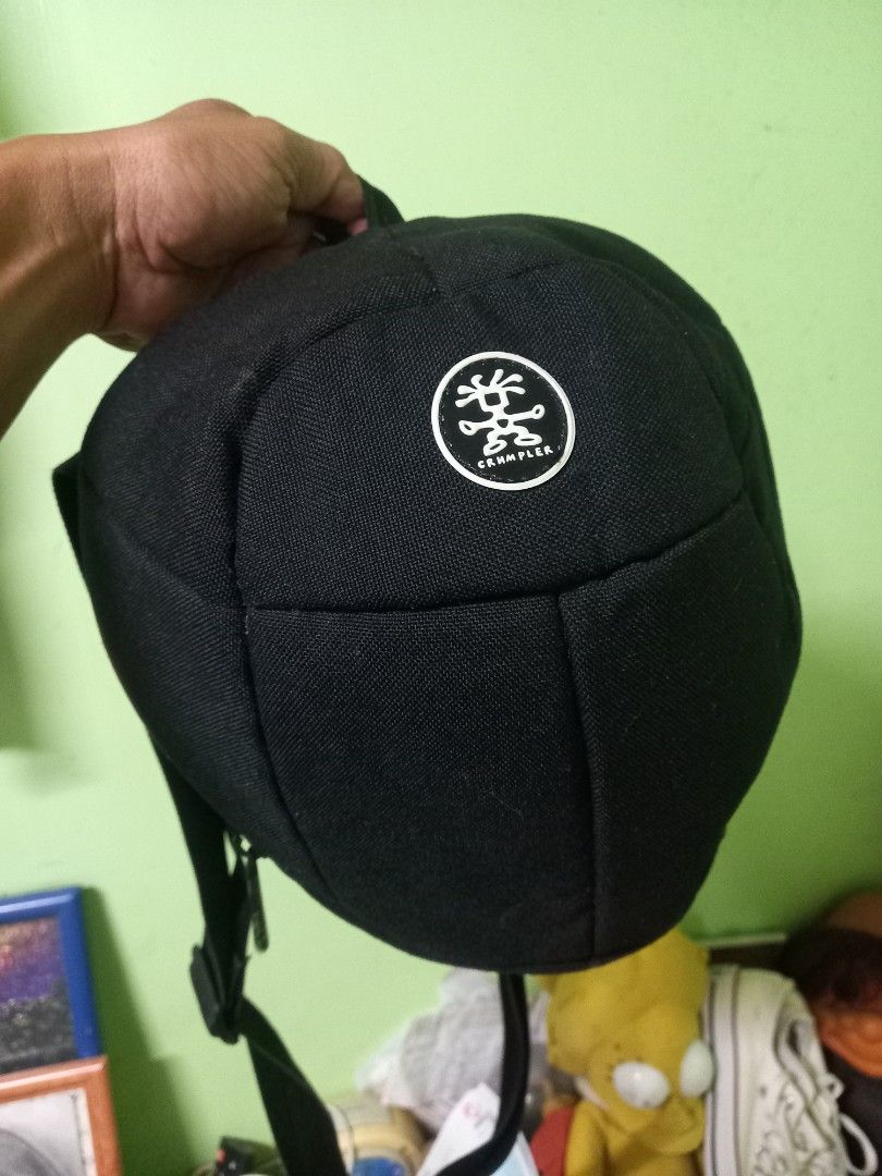 Crumpler Jimmy B 300 Sling Bag (Category: Sling Bags) located in Manila. Submitted by cristobalc40322 (Listing ID 1409284393, Image 1). Description: Black Crumpler Jimmy B 300 sling bag. Features a main compartment with a red zipper and an internal pocket. The bag has an adjustable strap and a mesh back panel for comfort. The Crumpler logo is visible on the front. EXCELLENT CONDITION NO ANYDAMAGE NO ANYSTAIN NO SCRATCHES NO FLAWS NO FLUFF LOCATIO