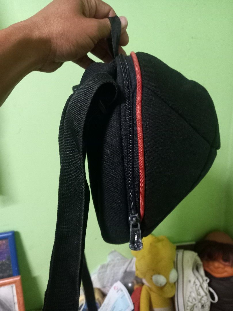 Crumpler Jimmy B 300 Sling Bag (Category: Sling Bags) located in Manila. Submitted by cristobalc40322 (Listing ID 1409284393, Image 3). Description: Black Crumpler Jimmy B 300 sling bag. Features a main compartment with a red zipper and an internal pocket. The bag has an adjustable strap and a mesh back panel for comfort. The Crumpler logo is visible on the front. EXCELLENT CONDITION NO ANYDAMAGE NO ANYSTAIN NO SCRATCHES NO FLAWS NO FLUFF LOCATIO