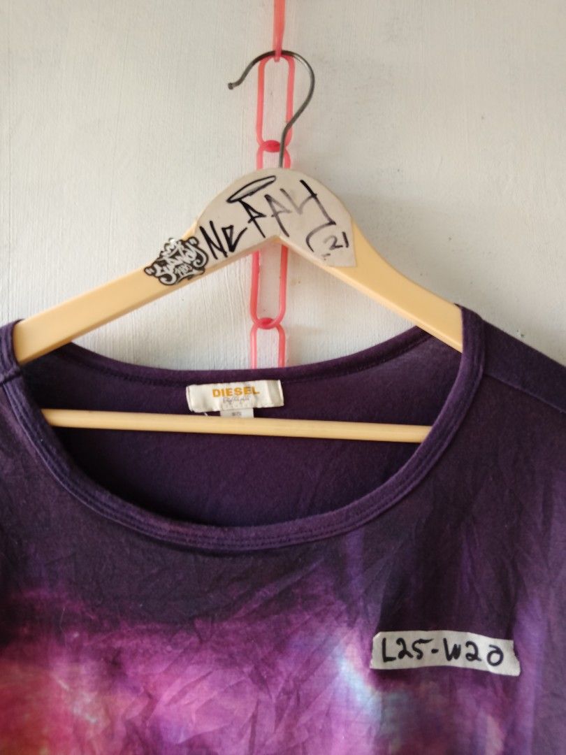 Diesel Graphic Print T-shirt (Category: Blouses) located in Naga. Submitted by neppyboy (Listing ID 1409311699, Image 2). Description: - Diesel graphic print t-shirt - Purple color - Unique layered design with black panel - Round neck - Short sleeves - Diesel logo visible - Features a unique graphic print just avail any items and take it for free.