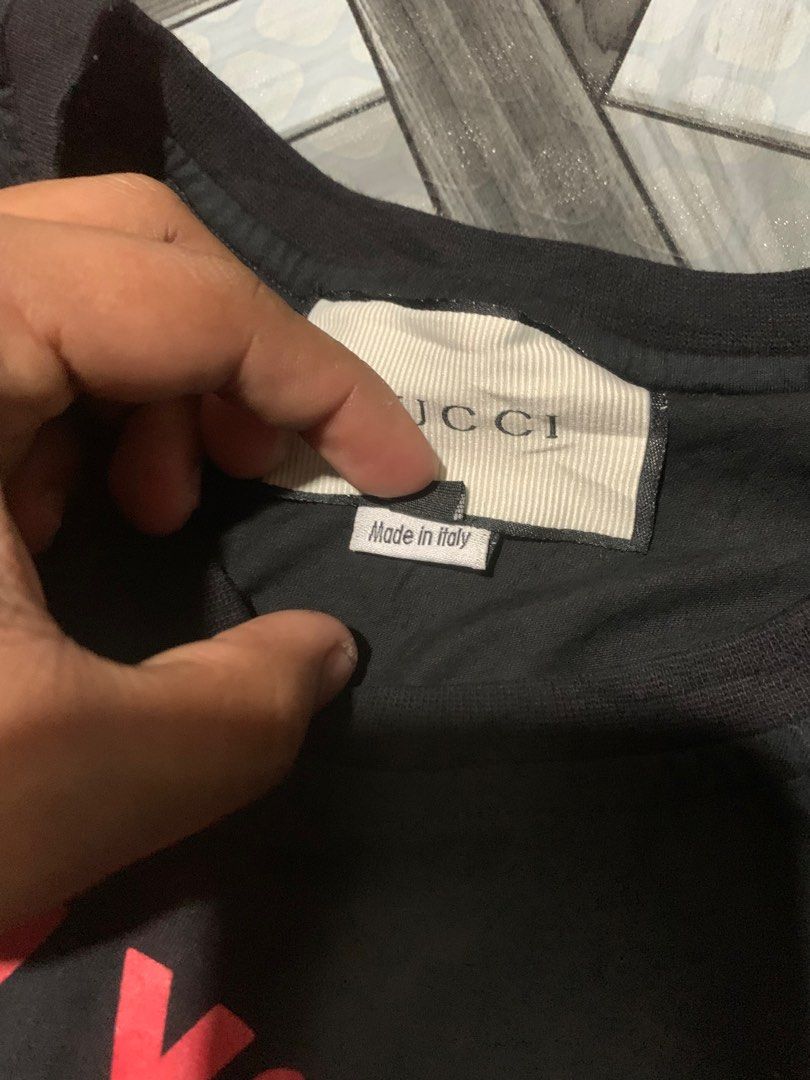 Gucci 'Guccify Yourself' Snake Tee (Category: Luxury Apparel) located in Cagayan de Oro. Submitted by agboysalis60090 (Listing ID 1409352903, Image 3). Description: Authentic Gucci t-shirt featuring the 'Guccify Yourself' graphic with a snake design. The shirt is black with red lettering and a red snake graphic. It is made in Italy and has a size M label. The shirt has the Gucci logo on the tag..