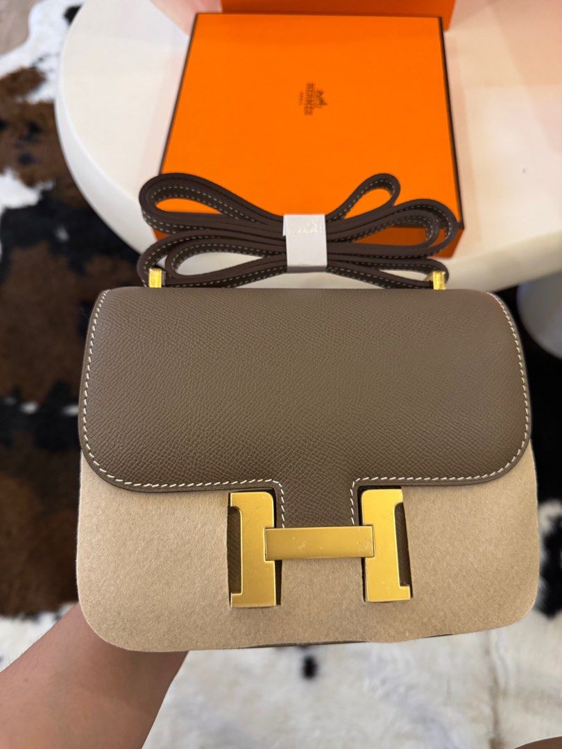 Hermes Mini Constance Bag (Category: Luxury Bags & Wallets) located in Manila. Submitted by beaumontandco (Listing ID 1409286818, Image 1). Description: - Hermes Mini Constance bag - Two-tone design: brown leather flap, beige suede body - Features gold-tone 'H' clasp - Includes matching shoulder strap - Leather-lined interior with slip pocket - Comes with original Hermes box.