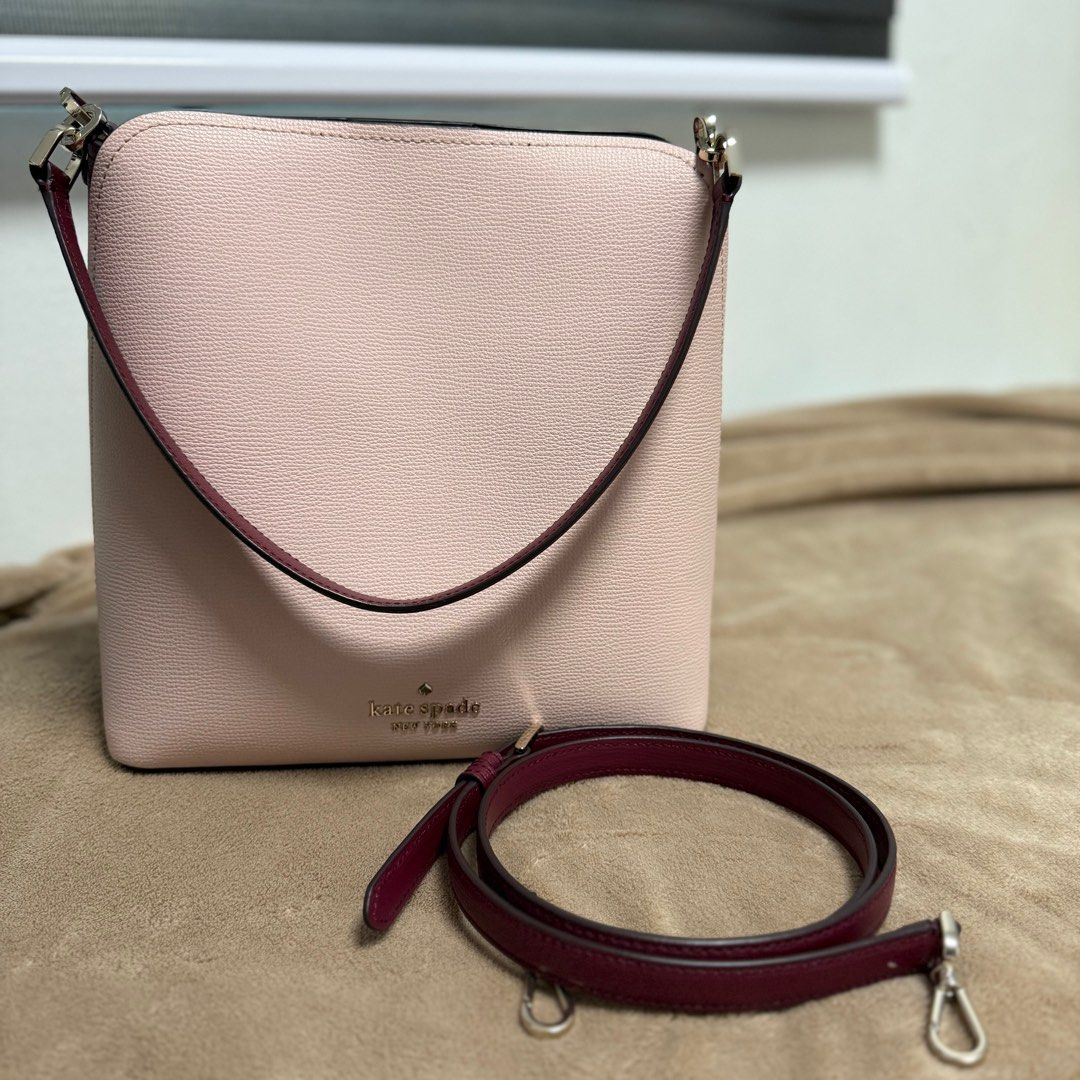 Kate Spade Darcy Bucket Bag (Category: Luxury Bags & Wallets) located in Caloocan City. Submitted by madz_stuff (Listing ID 1409262853, Image 2). Description: - Size: 19.5cm L x 20cm H x 10.5cm W - Weight: 0.5kg - Handle drop: 6” - Strap drop: 19” - Material: Refined grain leather - Metal pinmount logo - Burgundy trim and strap - Detachable shoulder strap - Burgundy interior with small pocket - Magnetic snap closure - Exterior back slip pocket - 