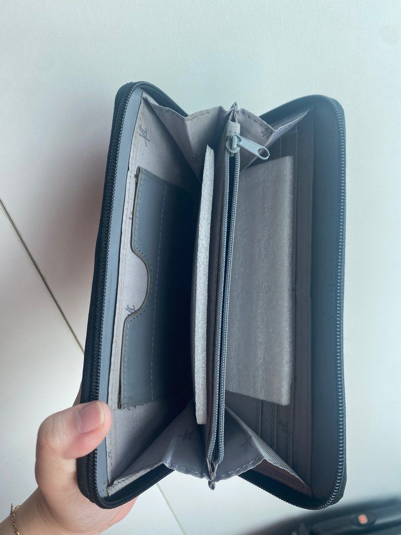 Kenneth Cole New York Black Wallet (Category: Wallets & Card holders) located in Pasig City. Submitted by angelaaaj (Listing ID 1409313756, Image 2). Description: - Black Kenneth Cole New York wallet - Zip-around closure - Multiple interior compartments for cards and cash - Zippered coin pocket - Silver-toned brand plate - Light grey interior.