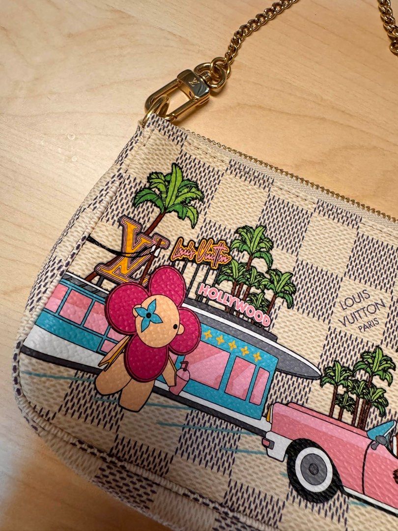 Louis Vuitton Mini Pochette Accessoires (Category: Luxury Bags & Wallets) located in Taguig. Submitted by luxeria_ (Listing ID 1409422611, Image 3). Description: - Authentic Louis Vuitton Mini Pochette Accessoires - Unique Hollywood-themed design - Includes original Louis Vuitton box and ribbon - Features a checkered pattern with colorful illustrations - Gold-tone zipper and small strap - Ideal for carrying small essentials.